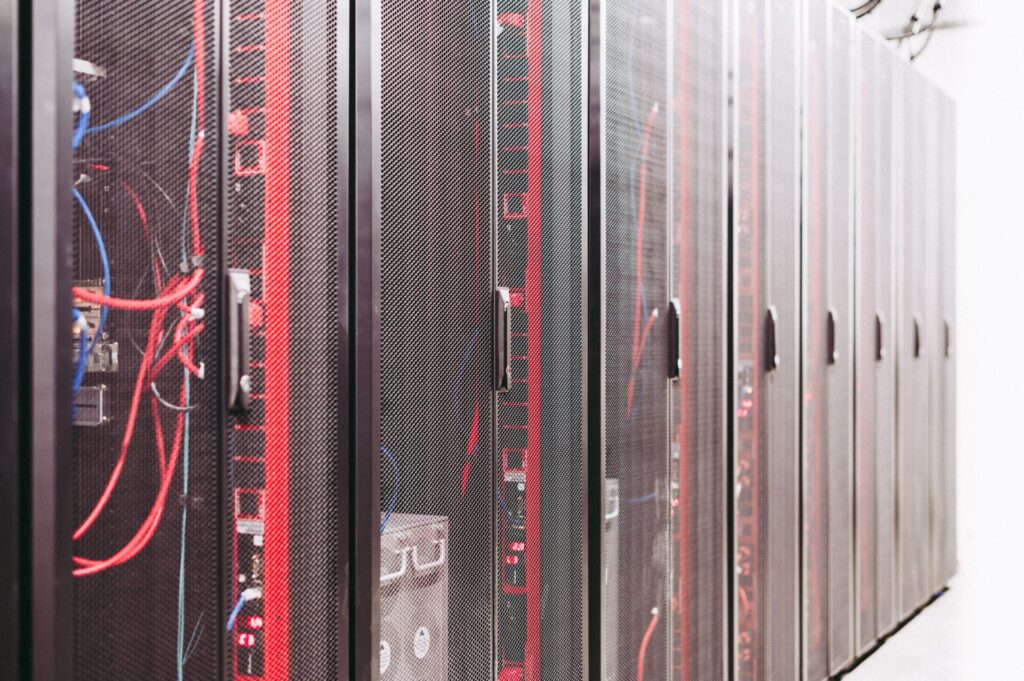 Rows of server racks and network cables in a data centre.