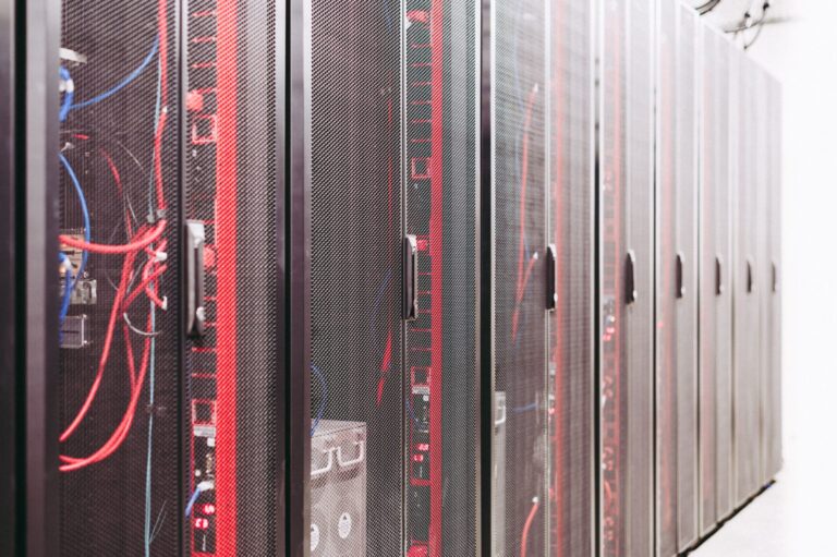 Rows of server racks and network cables in a data centre.